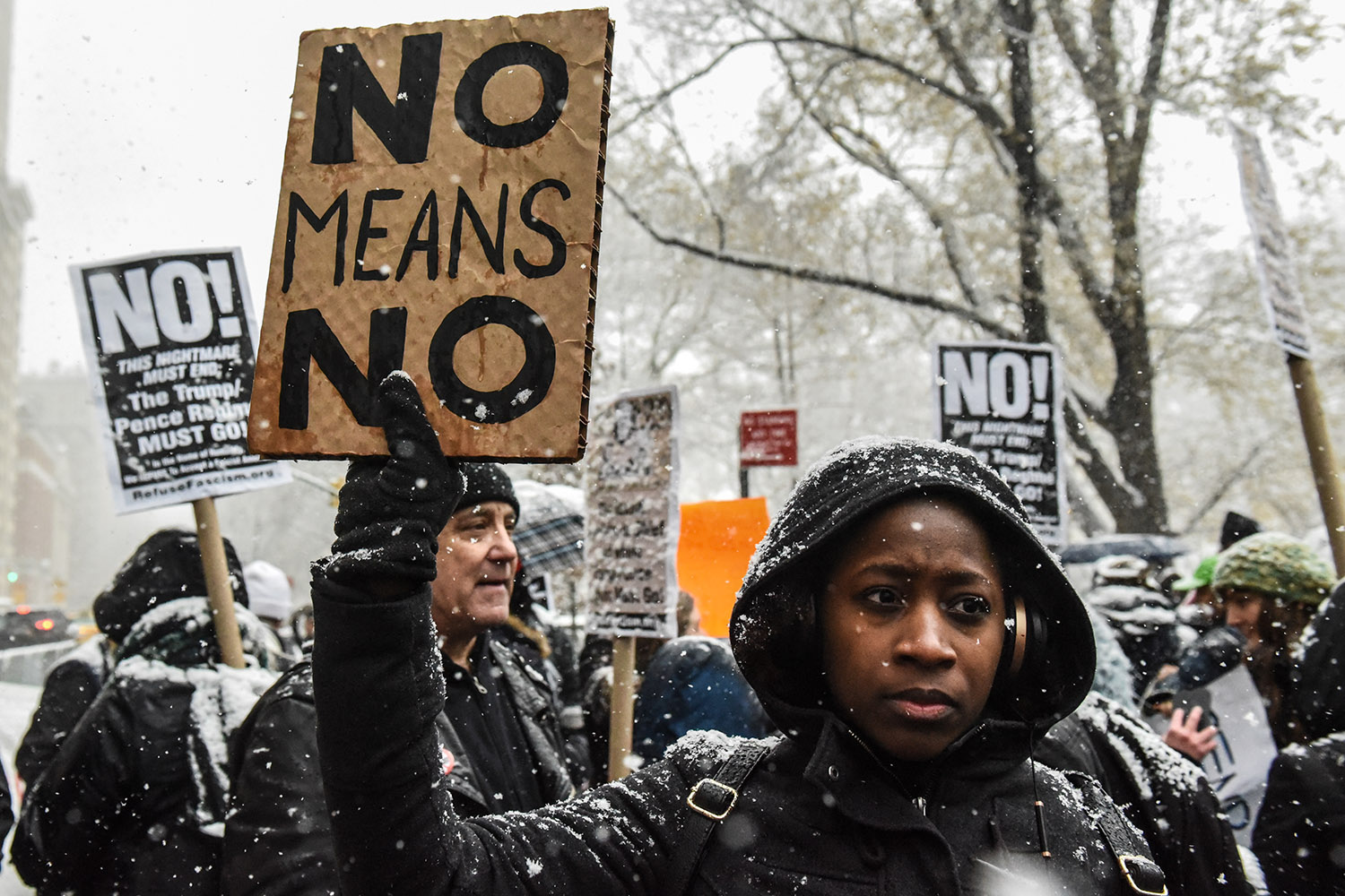 NEW YORK, NY - DECEMBER 09: People carry signs addressing the issue of sexual harassment at a #MeToo rally outside of Trump International Hotel on December 9, 2017 in New York City. (Photo by Stephanie Keith/Getty Images)